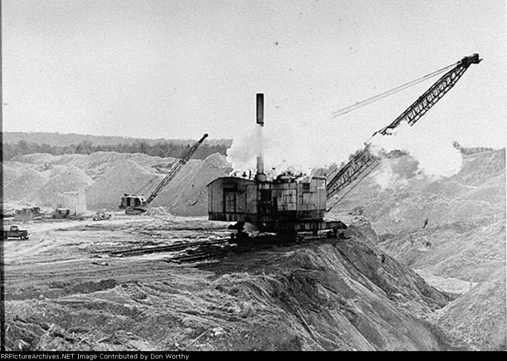 Big steam dragline piles chalk(kaolin) on the bank and smaller dragline loads chalk in a "Blunger"